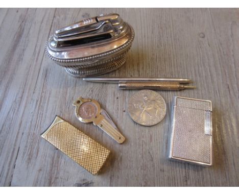 Dupont silver plated cigarette lighter, a Tiffany and Co. silver mounted pen, two other cigarette lighters and sundries 