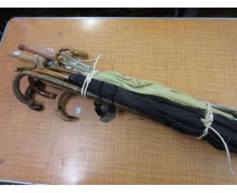 Two silver mounted walking sticks together with a quantity of other various vintage walking sticks, umbrellas and riding crop