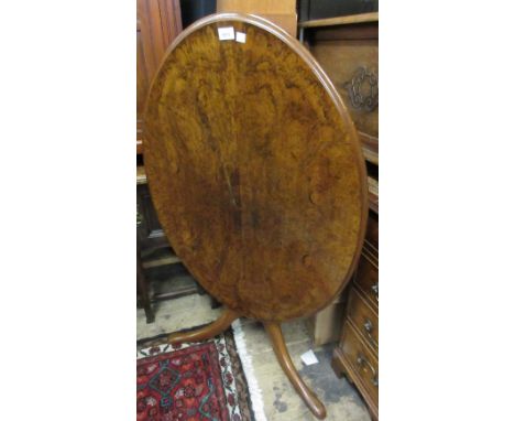 Victorian oval figured walnut tilt top table on mahogany turned centre column and tripod support 