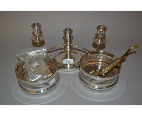 Pair of silver plated and turned wooden bottle coasters, plated three branch candelabra, brass nutcracker and a bag of condim