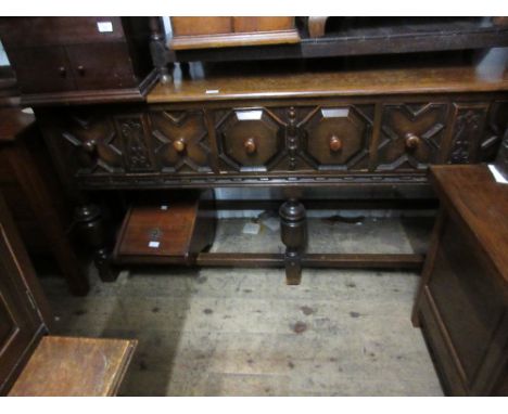 Early 20th Century oak dresser base, the moulded top above three moulded panel drawers, raised on bobbin supports with stretc
