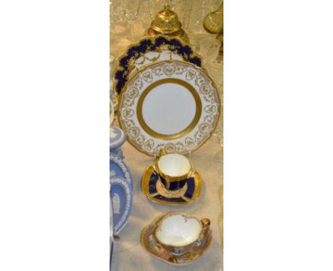 A Meissen quatrefoil cabinet cup and saucer, decorated with alternating panels of figure in continental landscape and colourf