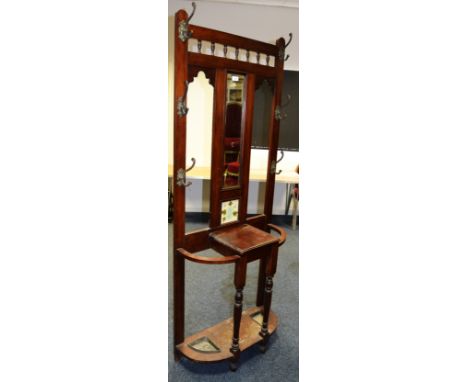 A late Victorian mahogany hall stand, rectangular bevel edge plate flanked by coat hooks, glove box and stick stands to base.