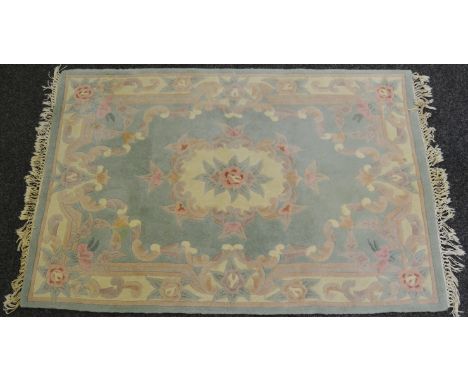 A Chinese woollen rug, with pink flowers on a light green ground, 122cm wide, 183cm long