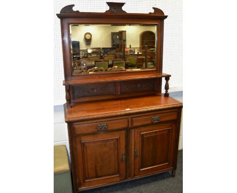 A Victorian mahogany chiffonier. mirror back above one shelf, turned supports, carved to frieze holding two panelled short dr