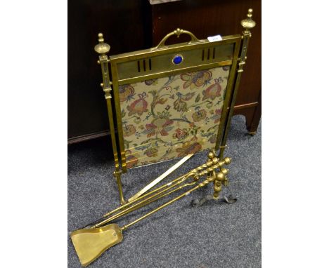 A brass and tapestry firescreen; andirons; implements