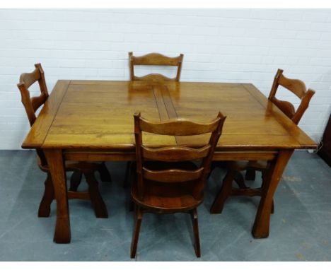 An oak dining suite comprising four ladder back chairs and an extending table, 46 x 99cm