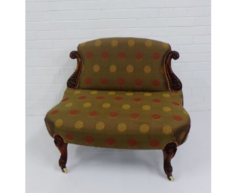 A late 19th century chair with upholstered back and seat with carved mahogany supports and ceramic castors,  72 x 90cm