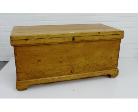 A vintage pine storage trunk with hinged lift up top and bracket plinth base,  52 x 104cm