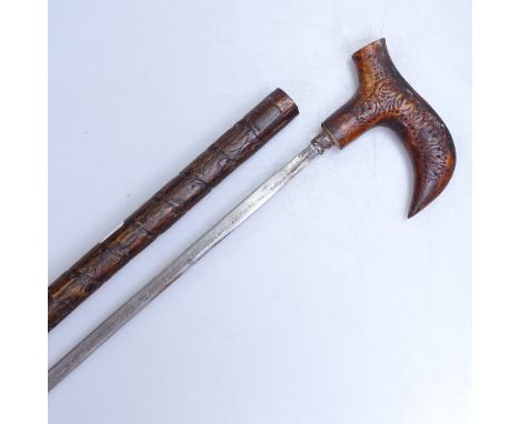 A carved wood sword stick, length 19" 