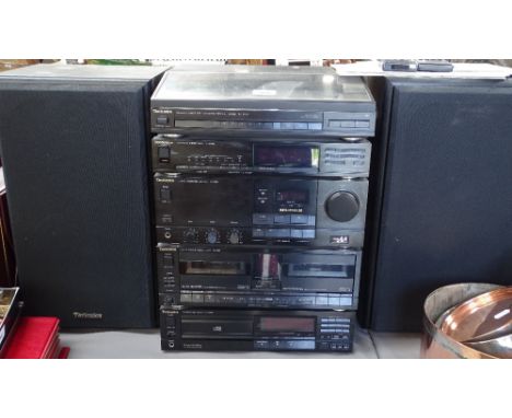 A Technics stacking musical system, comprising turntable, stereo tuner, amplifier, cassette deck, CD player and speakers 