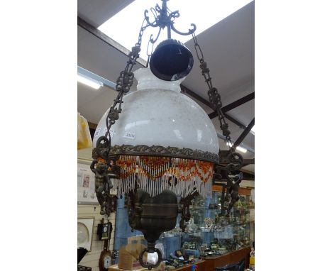 A brass and glass hanging oil lamp, converted to electricity, height 24" approx 