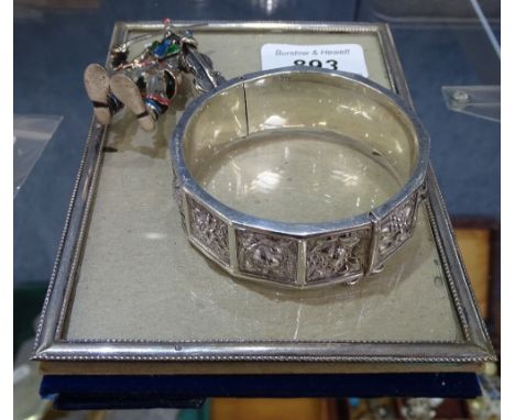 A silver-fronted photo frame, and embossed and panelled silver bangle, and a silver and enamelled violin figure modelled as a