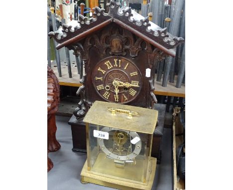 A Black Forest carved wood mantel clock, height 18", and a German Kundo clock 