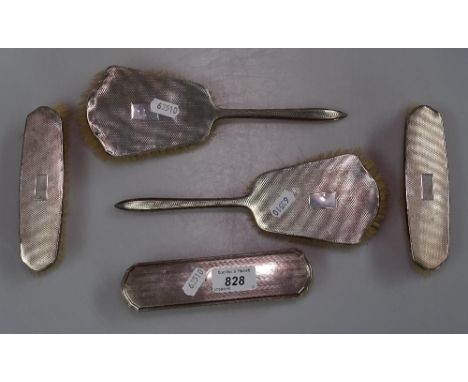 A 4-piece engine turned silver-backed brush set, and another 