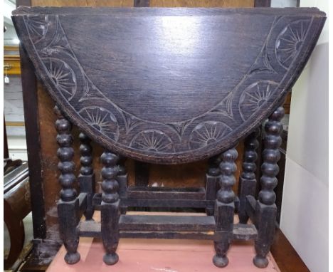 A carved oak oval gateleg table, on bobbin turned legs, W75cm 