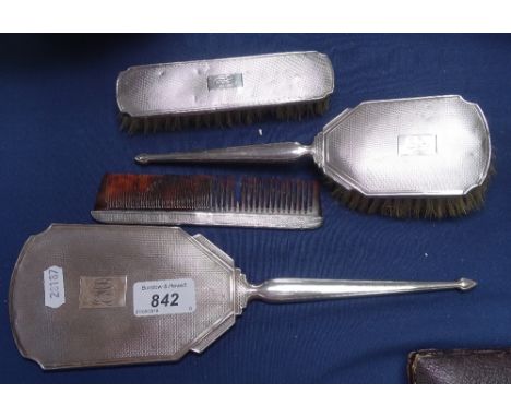 A 4-piece engine turned silver-backed brush, mirror and comb set 