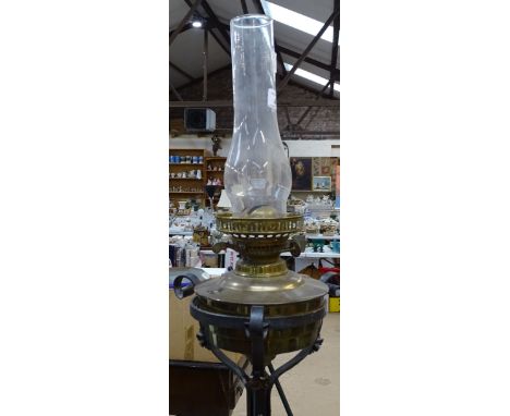 A Victorian wrought-iron adjustable standard lamp, with oil lamp fitting 