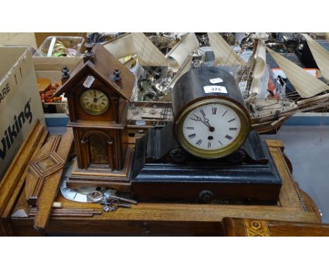 An oak-cased wall clock, a miniature longcase clock, and an ebonised mantel clock 