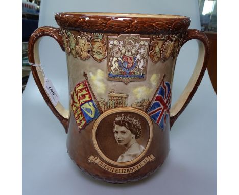 A Royal Doulton 1953 loving cup, with portraits of Queen Elizabeth I and II, 10.25" 