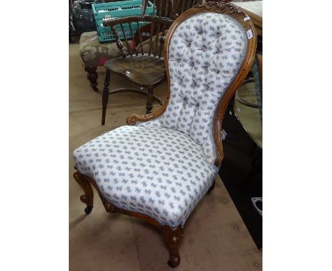 A Victorian button-back upholstered nursing chair, with carved mahogany show wood, together with a pair of curtains, a pelmet