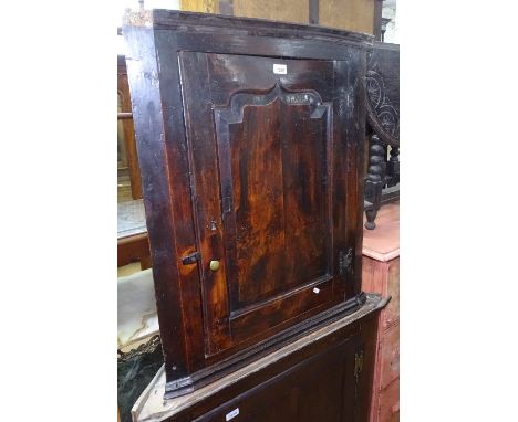 A small 18th century oak hanging corner cabinet, with fielded panel door, W75cm 