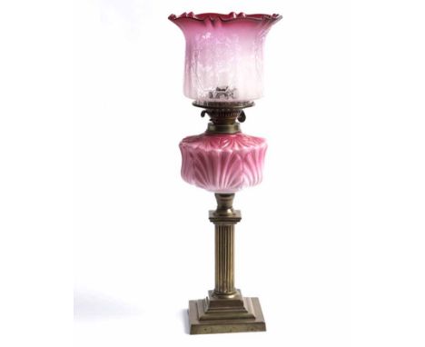 VICTORIAN BRASS OIL LAMP WITH CRANBERRY GLASS SHADE
with pink floral font, on stepped square base, 57cm high