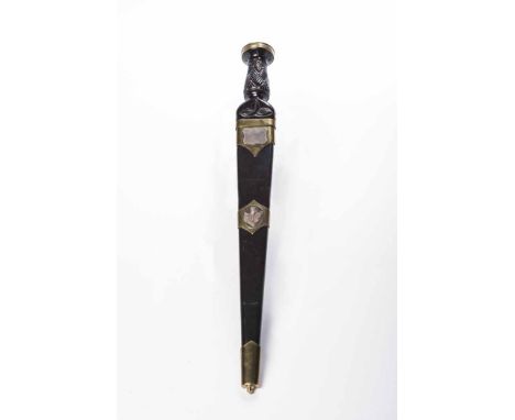 20TH CENTURY MILITARY STYLE DIRK
with 30cm double fullered blade, the carved ebonised hilt with brass studs and mounts, the l