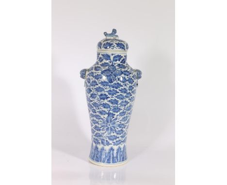 19th century Chinese blue and white baluster vase and domed cover, the body decorated with flowers on a ground of leaves with