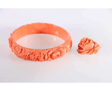 Mediterranean carved coral bangle, and a carved coral brooch, both depicting flowers.  (2)  Coral bangle - chip to at least o