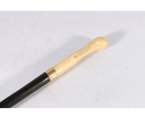 Antique walking stick, the carved ivory handle modelled as a claw holding an egg, 15ct gold band, 86cm long. 