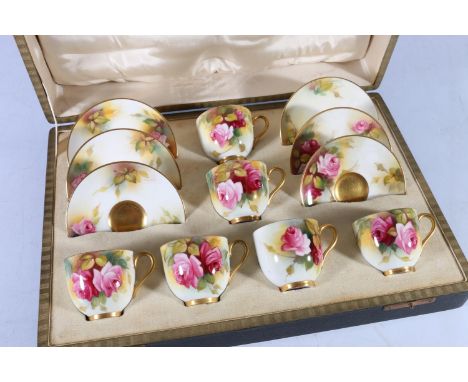 Royal Worcester twelve piece porcelain coffee set hand-painted with rose design, by M Hunt and Spilsbury, cased. Some surface