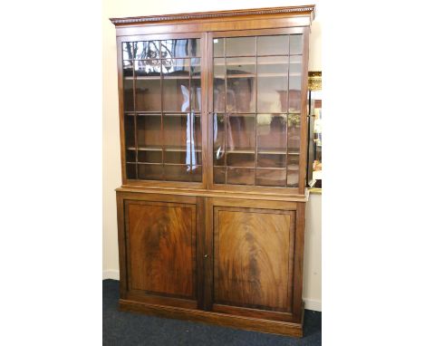 Late 19th century mahogany cabinet bookcase, the moulded cornice with dental work frieze above two astragal glazed doors abov