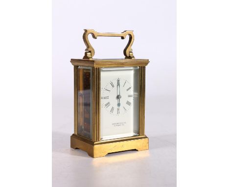 Garrard & Co. of London brass cased carriage clock, the rectangular enamel dial bearing Roman numerals, the case of conventio