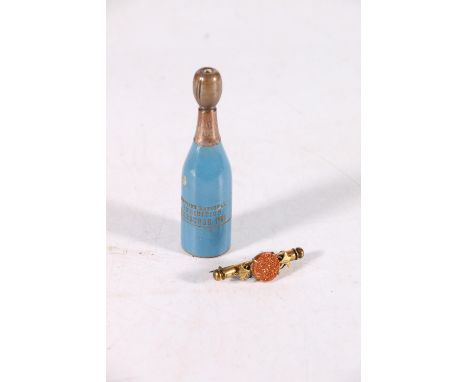 Souvenir needle holder from the Scottish National Exhibition in Edinburgh, 1908, in the form of a champagne bottle, a thimble