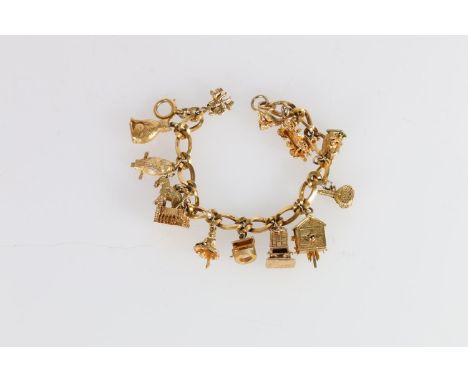 9ct gold fancy curb link charm bracelet, with thirteen dependant charms including cat, owl, goat, ballerina, well, cuckoo clo