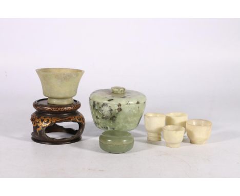 Jade hard stone cups, jars and covers, and small bowls to include a green jade cup with flaring rim,&nbsp; lacquered stand, e