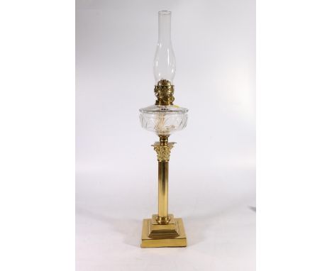Early 20th century Duplex brass oil lamp, with glass reservoir, above a fluted column, on step base. 