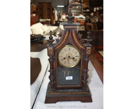 A 19th c. Rosewood and Walnut architectural Gothic style Mantle Clock marked Jungers to the face.  The pediment top having th