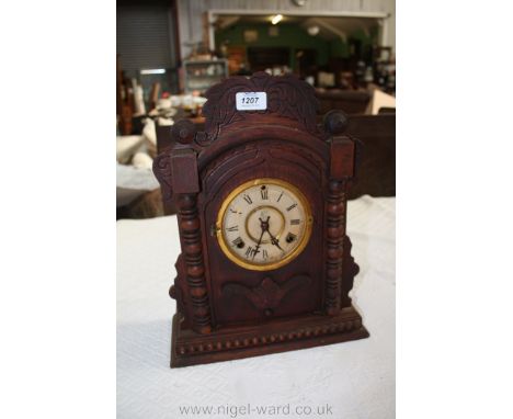 A late 19th c. Oak cased ornamental Mantle Clock, having fret cut and carved pediment top, half turned column detail and fret