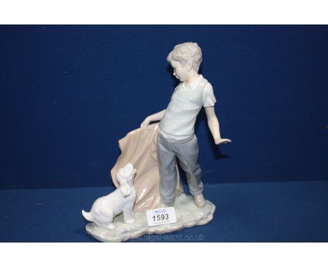 A Nao figure of a boy with a dog. 9 1/2'' tall.