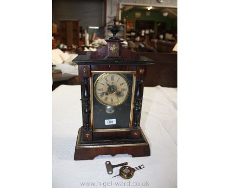 A German Rosewood and ebonised architectural Mantle Clock, ebonised finial to the pediment top with brass cross motif.  Singl