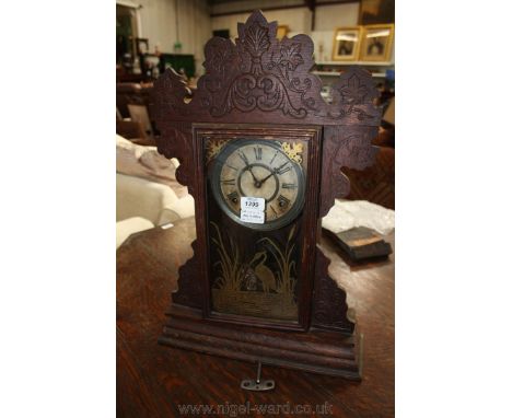 A Victorian Oak cased ornate Mantle Clock, having fret cut top and corbel style supports with carving.  The single glazed doo