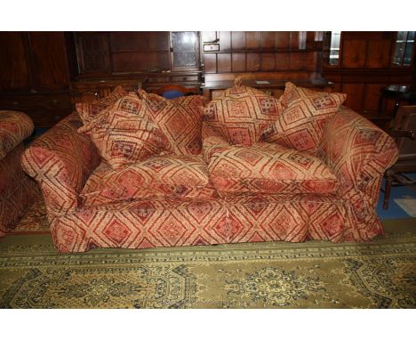 A large modern two seater Settee in fawn, brown and deep red Aztec style pattern fabric upholstery with six matching scatter 