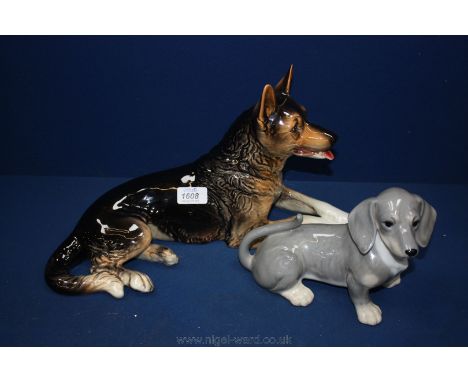 A figure of a large Goebel Dachshund together with a large figure of an Alsatian