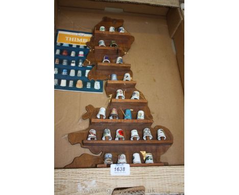 A quantity of collector's Thimbles including Aynsley, Wedgwood, Royal Worcester and Caverswall, Limoges, etc. on a wooden dis
