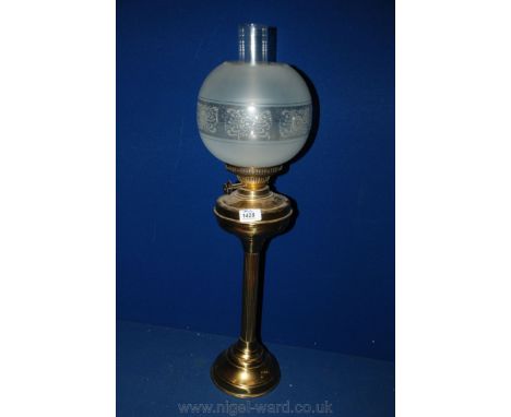 A Brass Oil Lamp with etched glass shade and chimney