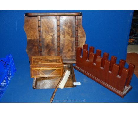 A wooden spoon rack, a wooden letter rack, a wooden crumb tray and brush and a marquetry trinket box.