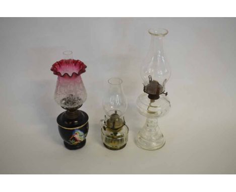 Group of three Victorian small proportioned oil lamps to include a clear glass circular  stepped column oil lamp with clear f