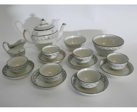 Late 18th century Newhall part tea set in a cream and black trailing flower design,  comprising a teapot, cream jug, two vary